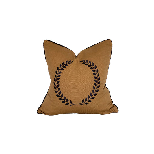 caramel gold square pillow with black handwork wreath