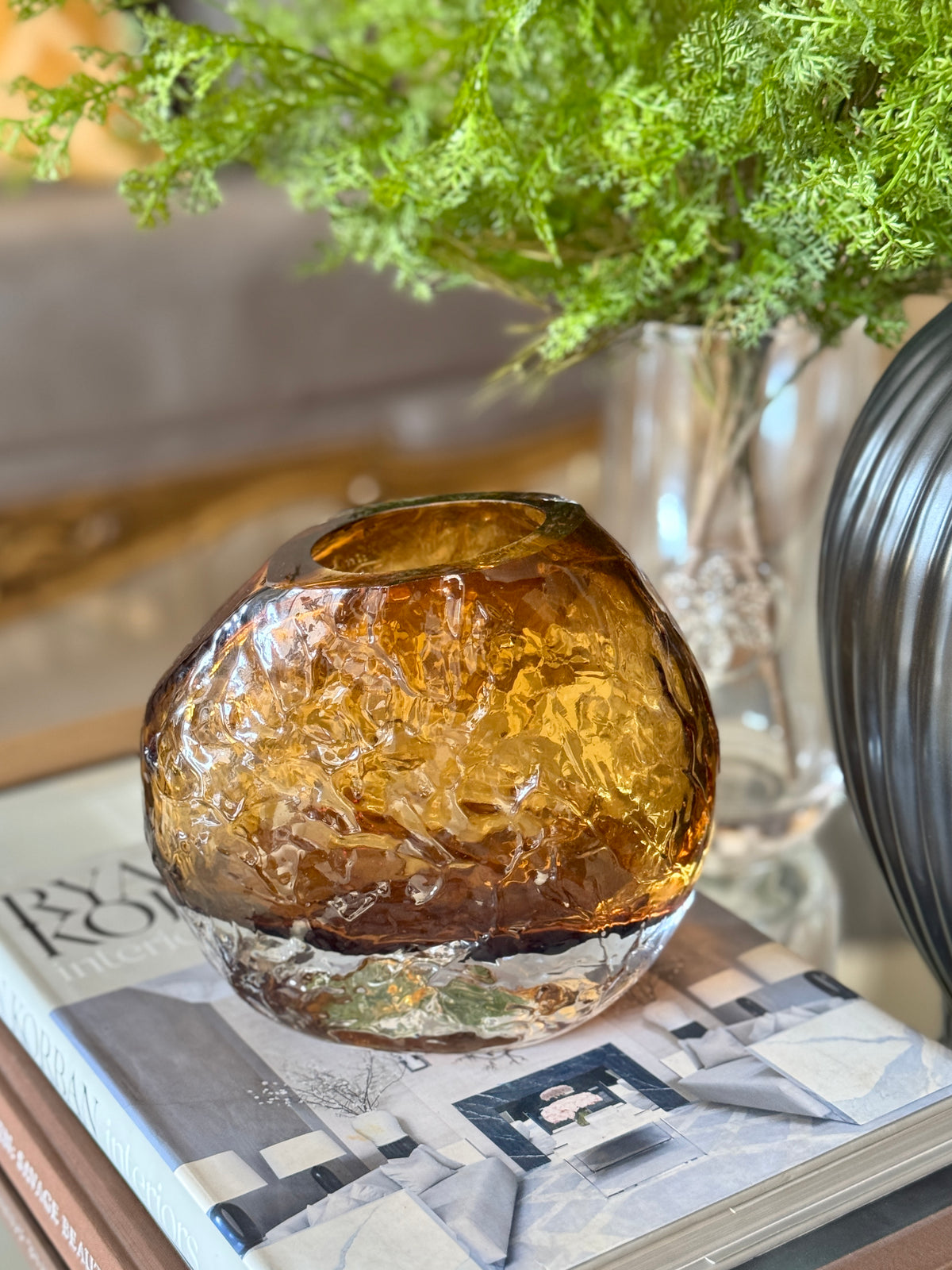 Close-up of The Amber Boulder Vase, showing its crinkled amber glass and clear base