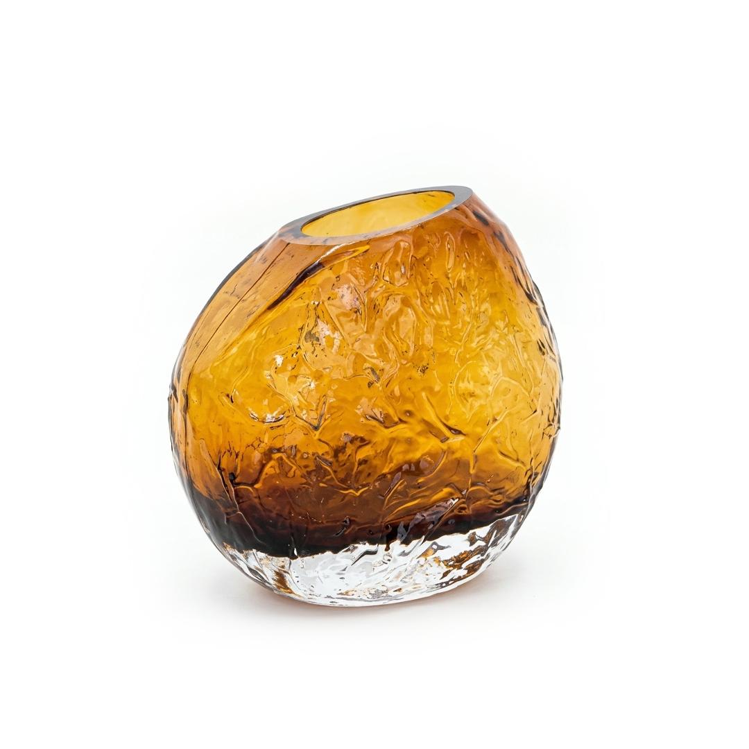 The Amber Boulder Vase, a textured amber glass vase with a slanted mouth and clear base
